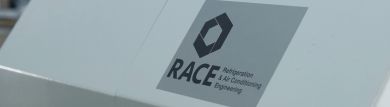 A silver sticker with the RACE logo